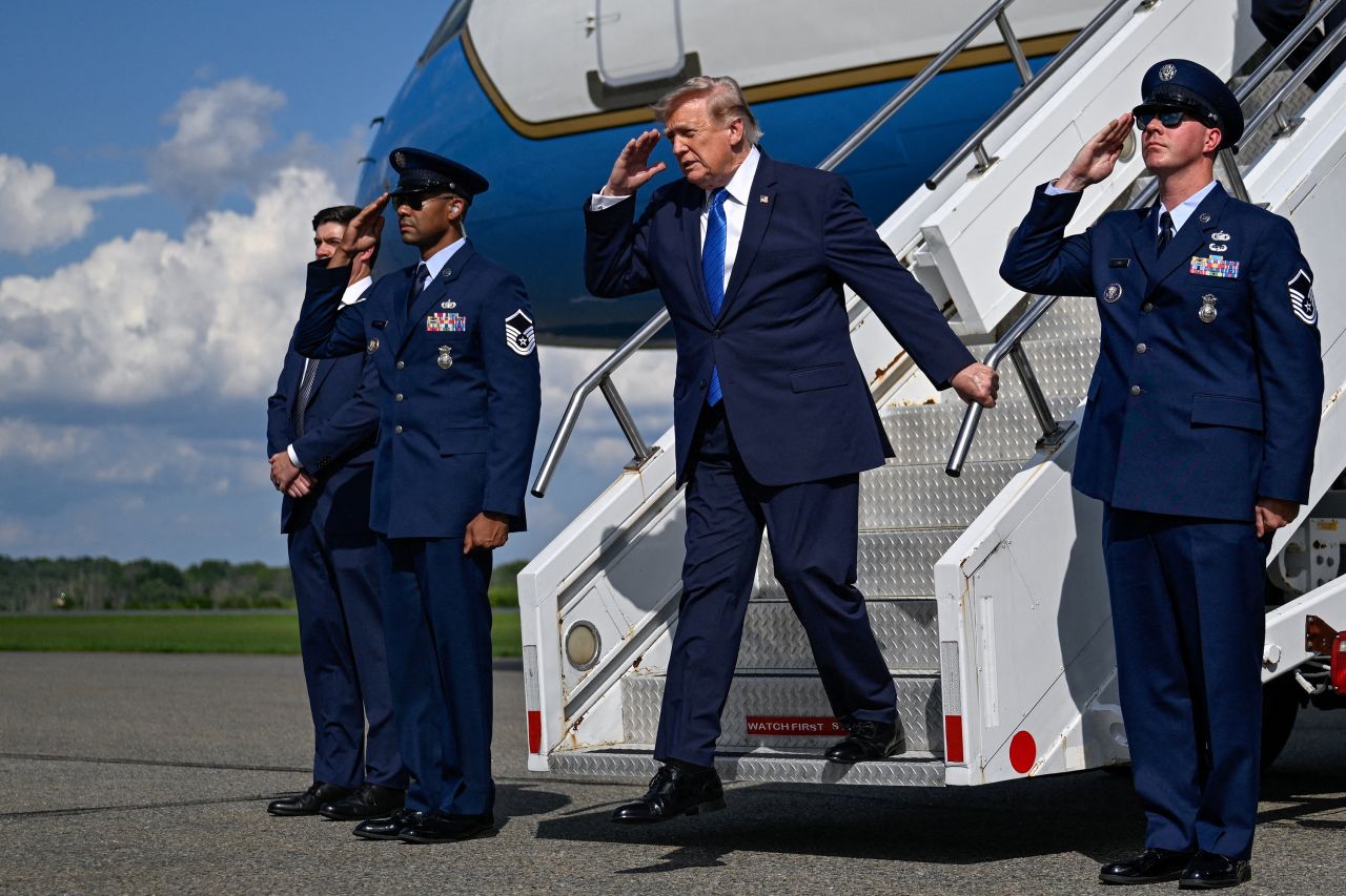 US President Donald Trump salutes as he disembarks Air Force One at Morristown Municipal Airport in Morristown, New Jersey, July 31.