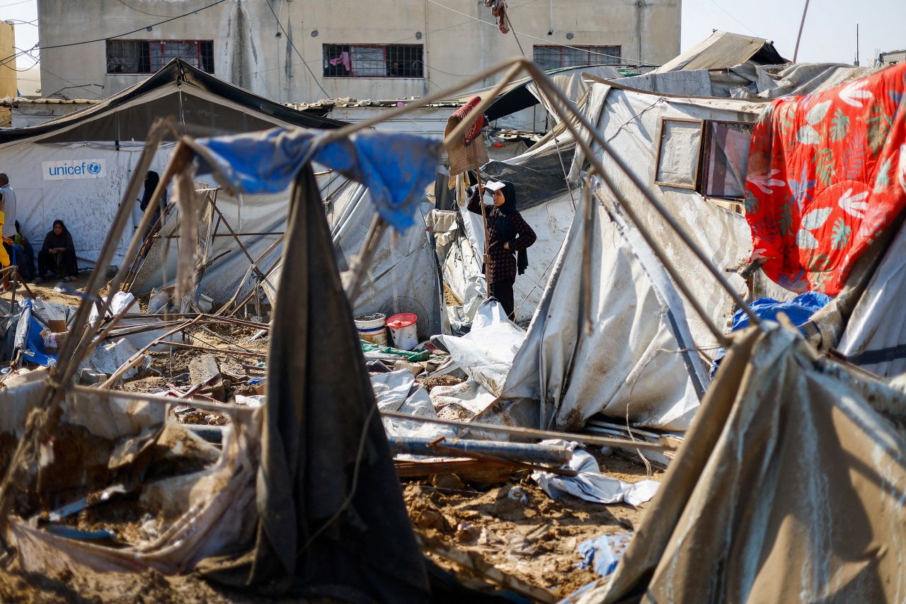 A woman looks at the site of an Israeli strike in Deir al-Balah, Gaza on Saturday.