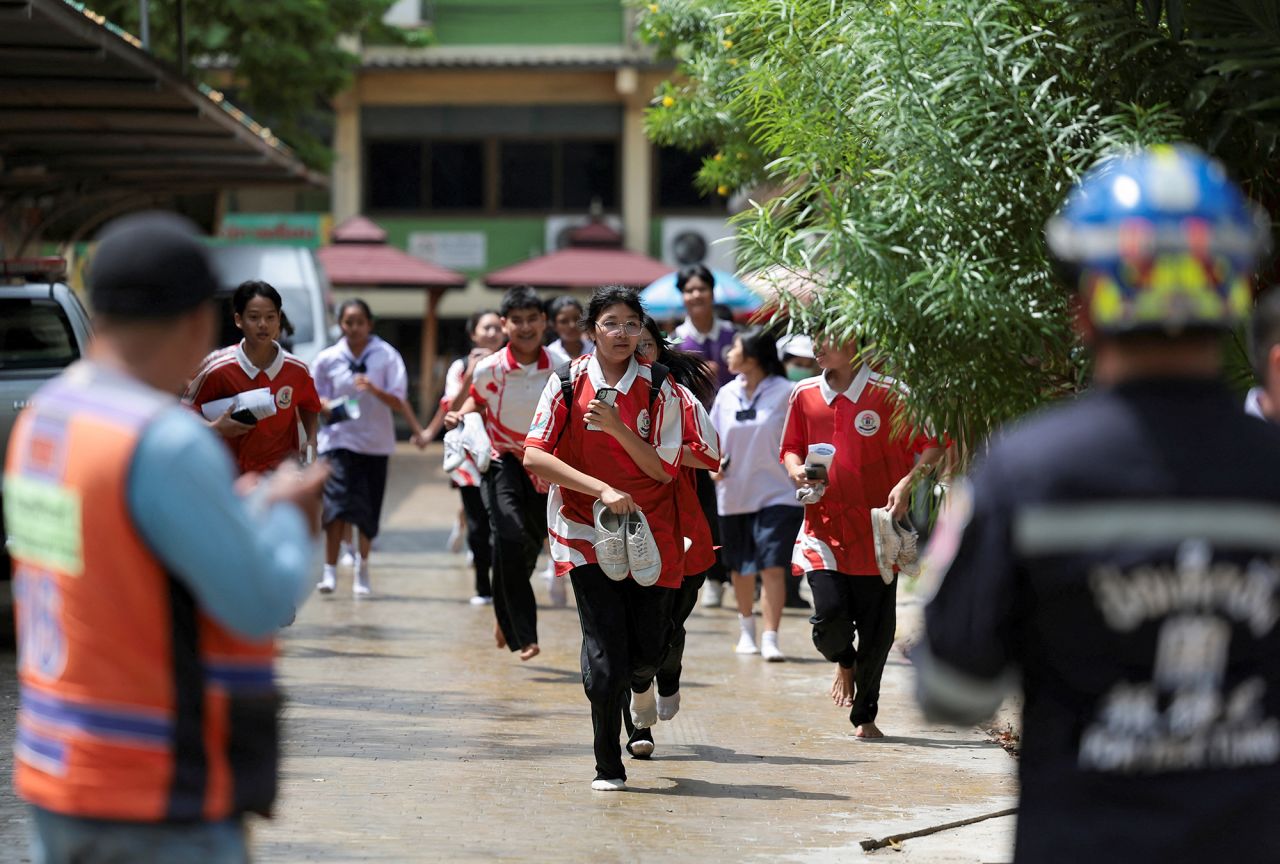 Students run as they evacuate from Debsirin Nonthaburi School after a shooting incident at the school in Bangkok, Thailand, on Friday August 7.