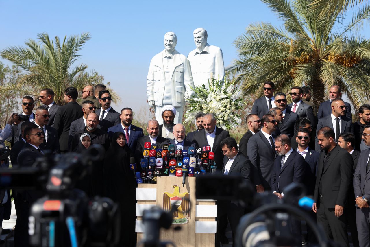 Iranian Parliament Speaker Mohammad Bagher Ghalibaf delivers a speech in front of statues of Iranian military commander Qassem Soleimani and Iraqi paramilitary commander Abu Mahdi al-Muhandis at the site where they were killed in a U.S. drone strike, near Baghdad International Airport, Iraq, on Wednesday.