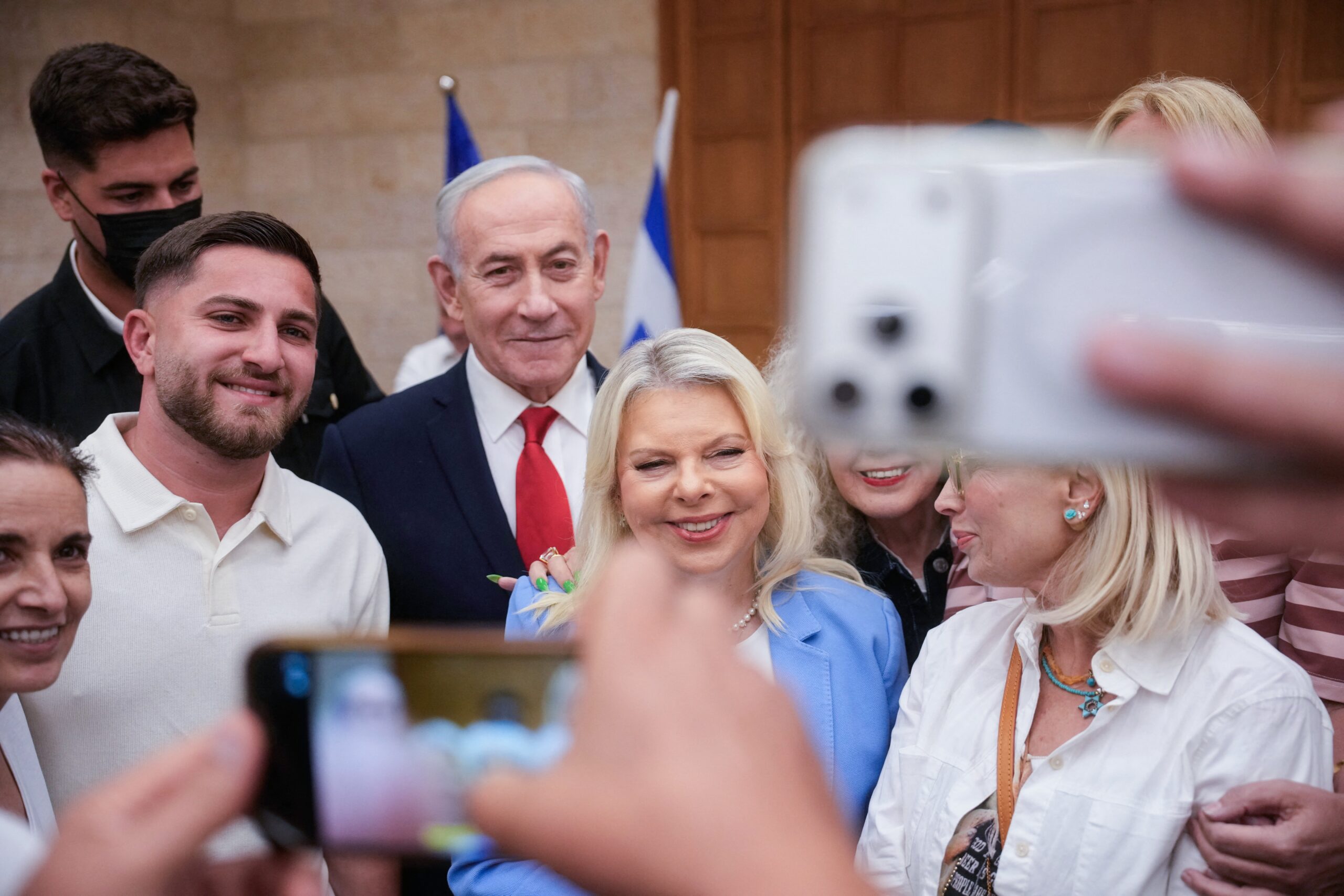 Israeli Prime Minister Benjamin Netanyahu, (C), and his wife, Sara, (C-R) arrive to cast their ballot at his party Likud's main polling station during primary elections ahead of Israel's general election in October in Jerusalem on August 17, 2026.