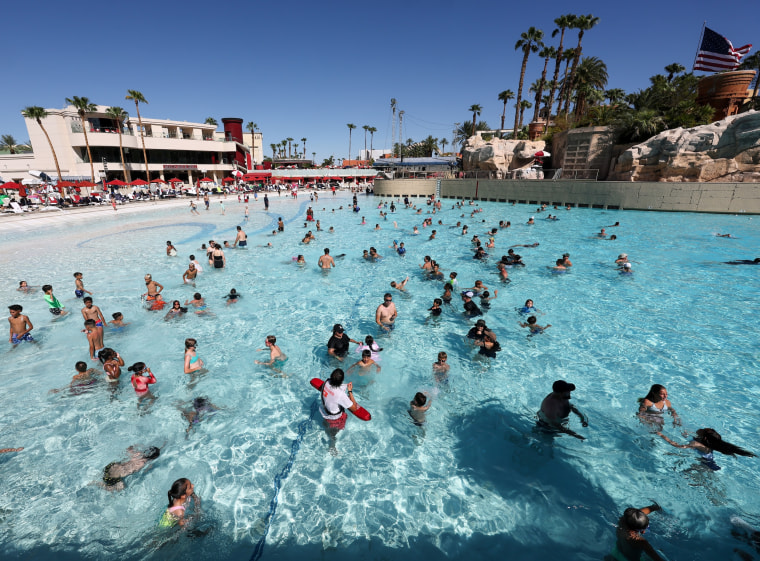 Image: Guests cool off in the wave pool to escape a heat dome.