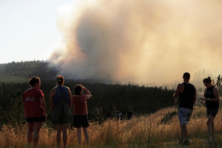People watch the Old Trails Fire in Spokane, Wash., on Saturday, Aug. 1, 2026.
