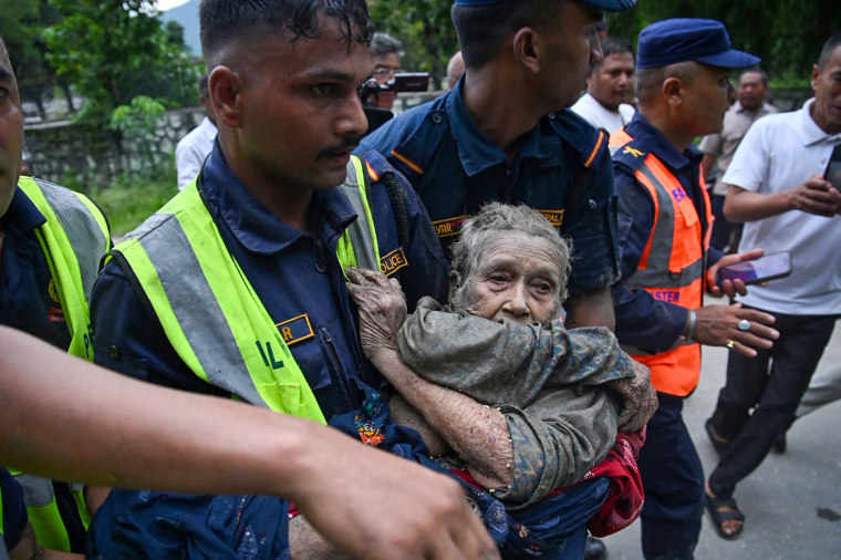 Police rescue a flooding victim in Devghat in Nepal's Nuwakot district on Aug. 26, 2026.