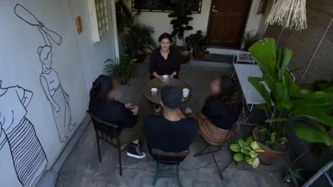 Reporter talking to employees who asked to remain anonymous