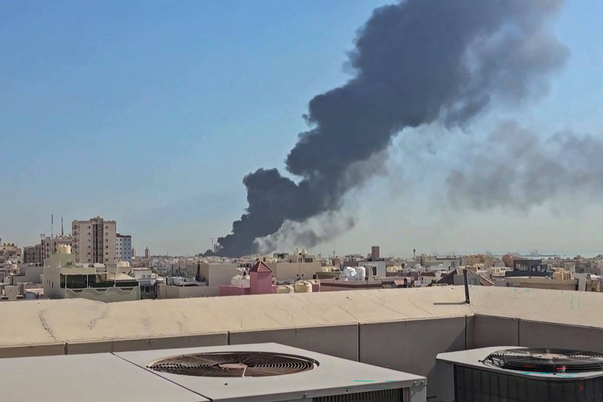 A plume of black smoke billowing over a town in Kuwait. The war in the Middle East has raised concerns about flying through the region, industry leaders say. Photo: AFP