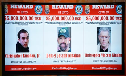 A graphic showing three wanted notices for Christopher Kinahan Jr, Daniel Joseph Kinahan and Christopher Vincent Kinahan, each offering a reward of up to $5 million for information leading to their arrest or conviction. Mugshots of the three men appear beneath their names, with an email address for submitting tips.