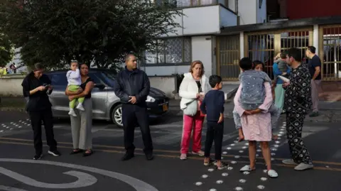 REUTERS/Luisa Gonzalez People gathered outside a building in Bogota