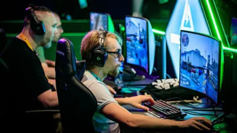 AFP via Getty Images Gamers play on computers during a gaming convention organised by Twitch in Rotterdam in 2024