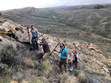 people with shovels  on a mountain