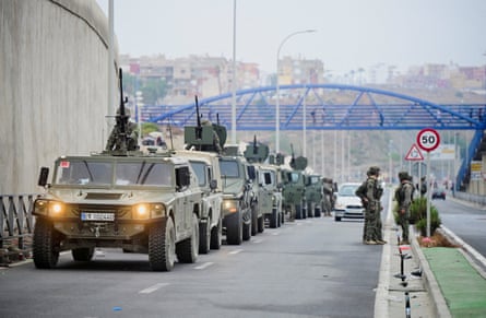 A line of military vehicles on a road at the Spanish-Moroccan border in Ceuta