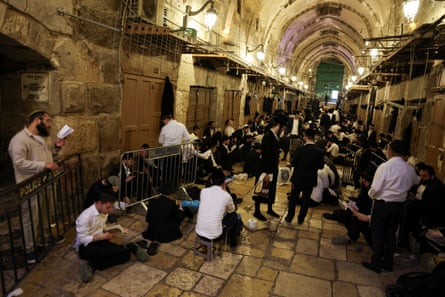 Jewish visitors pray at an entrance of al-Aqsa mosque compound.