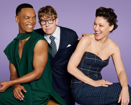 Johannes Radebe and Emma Willis smiling at each other, with Josh Widdicombe in between them.