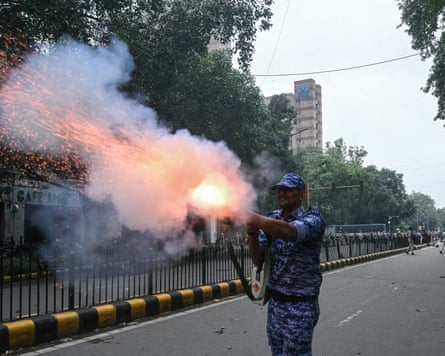 A Rapid Action Force (RAF) personnel fires a teargas shell to disperse supporters of the Cockroach Janta party (CJP) during a protest demanding the resignation of India’s Education Minister.