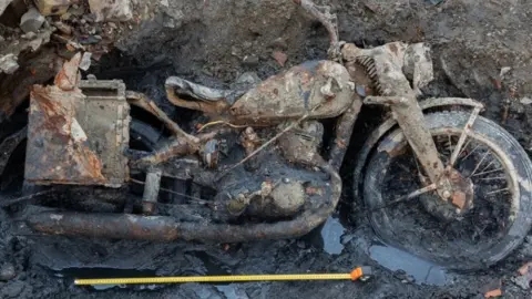 German War Graves Commission Image of motorcycle embeded in mud.