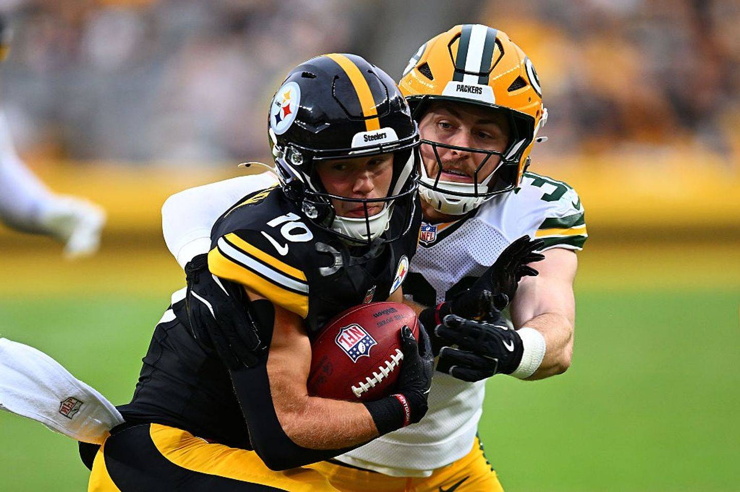 Pittsburgh's Kaden Wetjen, front, is tackled by green Bay's Nick Niemann.
