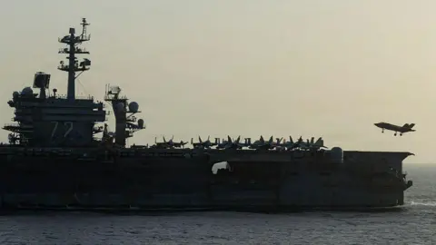 Getty Images Side view of USS Abraham Lincoln as a small jet lands on it