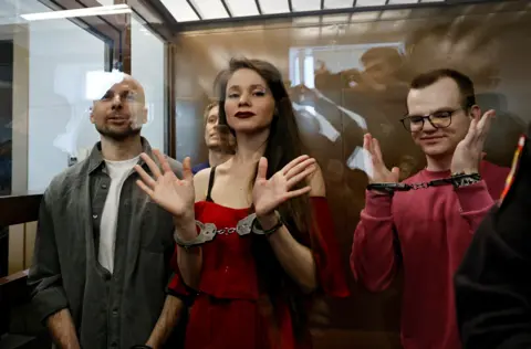 Reuters Antonina Favorskaya, Konstantin Gabov, Sergey Karelin and Artyom Kriger are handcuffed and standing in the dock during their trial.