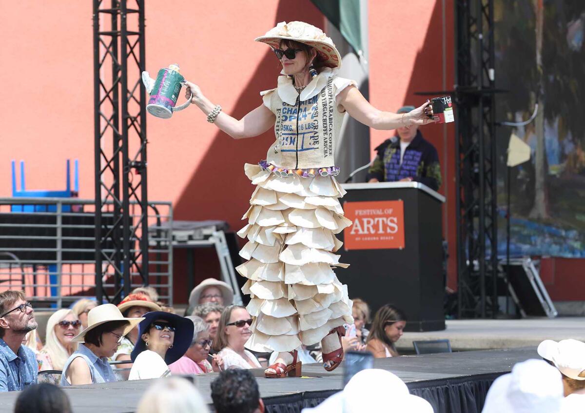 Model Allison Adams shows off artist Anne Moore's "Gimme a Cuppa Joe" at the Festival of Arts on Sunday.