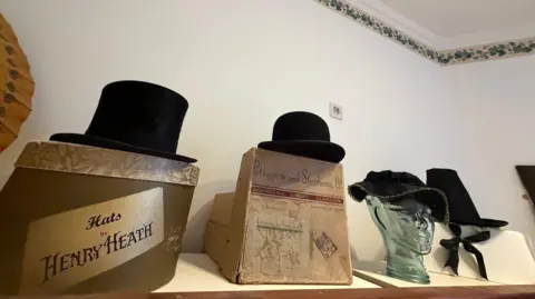 A selection of black hats on boxes
