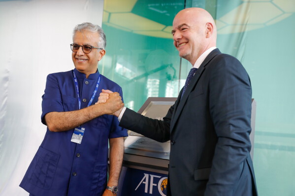 Asia Football Confederation President Salman Bin Ibrahim Al-Khalifa, left, poses with FIFA President Gianni Infantino during an inauguration ceremony for the new building of the Asia Football Confederation in Kuala Lumpur, Malaysia Tuesday, Oct. 30, 2018. (AP Photo/Vincent Thian, File)