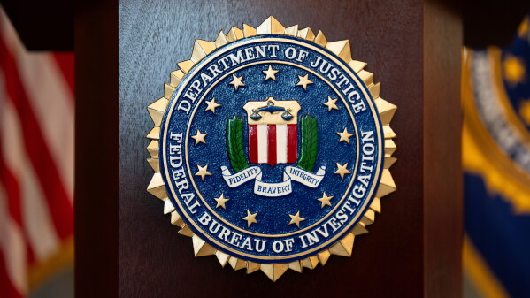 An FBI seal is displayed on a podium before a news conference at the field office in Portland, Ore., Jan. 16, 2025. (AP Photo/Jenny Kane, File)