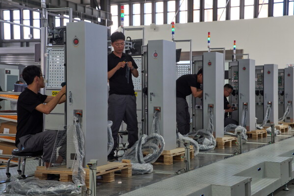 Workers assemble charging stations at the Mengma Intelligent Transportation Equipment Manufacturing Base in Hohot in northern China's Inner Mongolia province on Thursday, June 11, 2026. (AP Photo/Ng Han Guan, file)