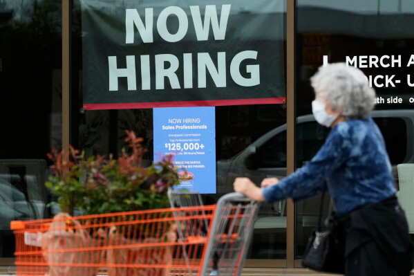 Hiring sign for sales professionals is displayed at a store, in Vernon Hills, Ill., Wednesday, April 15, 2026. (AP Photo/Nam Y. Huh, file)
