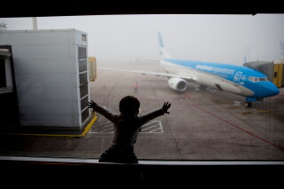 A child watches a plane at the Jorge Newbery airport in Buenos Aires, Argentina, April 14, 2016. (AP Photo/Natacha Pisarenko, File)