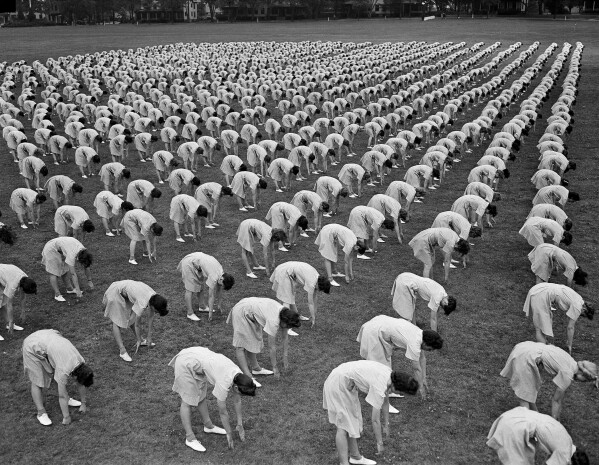 Over 2,000 members of the Women's Army Auxiliary Corps (WAAC) take part in a mass calisthenics exercise in Fort Oglethorpe, Ga., on May 15, 1943. (AP Photo/B.I. Sanders, File)