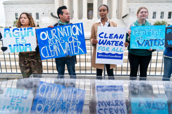 Bethsaida Sigaran, left, of Baltimore, her brother Jaime Sigaran, with American Rivers, and Thea Louis, with Clean Water Action, join other supporters of the Clean Water Act as they demonstrate outside the Supreme Court, Oct. 3, 2022, in Washington, as the court begins arguments in Sackett v. Environmental Protection Agency (EPA). (AP Photo/Jacquelyn Martin, File)