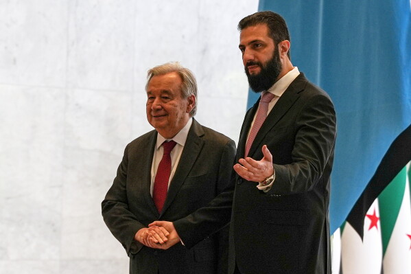 Syrian President Ahmad al-Sharaa, right, welcomes United Nations Secretary General Antonio Guterres at the Syrian presidential palace in Damascus, Syria, Saturday, July 25, 2026. (AP Photo/Omar Albam)