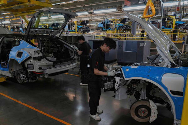 Workers assemble the Zeekr 001 EV models at the Chinese automaker Zeekr assembly plant in Ningbo, east China's Zhejiang Province, April 17, 2025. (AP Photo/Andy Wong, File)