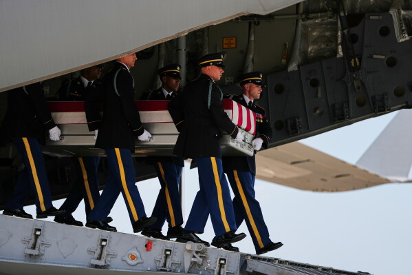 A U.S. Army carry team moves a transfer case containing the remains of 1st Lt. Tyler James Feehan of Ewa Beach, Hawaii, Wednesday, July 22, 2026, at Dover Air Force Base, Del. (AP Photo/Matt Rourke)