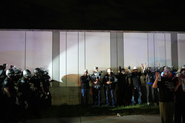 Law enforcement officers kettle protesters outside Delaney Hall detention center Sunday, May 31, 2026, in Newark, N.J. (AP Photo/Adam Gray, File)