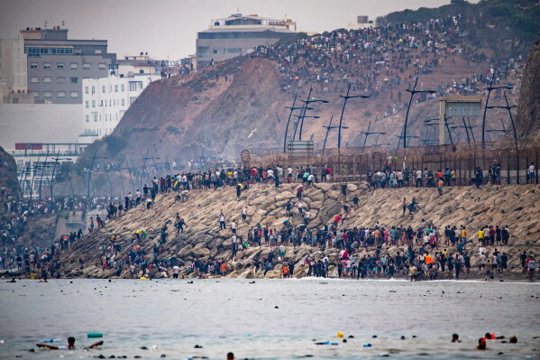 Migrants return to Morocco from the Spanish enclave of Ceuta, Friday, July 31, 2026. (AP Photo/Antonio Sempere)