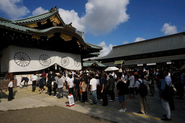 People wait to pray at the main hall at Yasukuni Shrine, which honors Japan's war dead, in Tokyo on Aug. 15, 2024, as the country marks the 79th anniversary of its defeat in the World War II. (AP Photo/Hiro Komae, File)