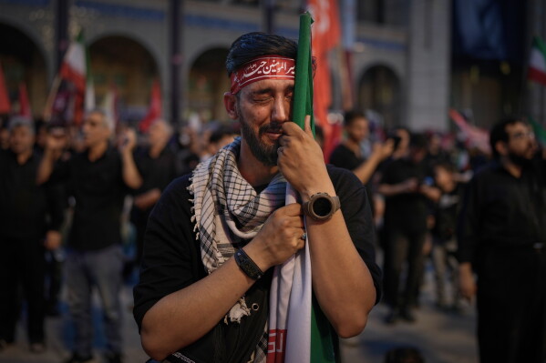 A man weeps during funeral ceremonies for slain Iranian Supreme Leader Ayatollah Ali Khamenei and members of his family at the Imam Khomeini Mosalla Grand Mosque in Tehran, Iran, Sunday, July 5, 2026. (AP Photo/Altaf Qadri)