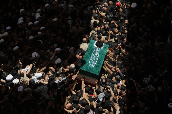 The coffin of the late Iranian Supreme Leader Ayatollah Ali Khamenei is carried by mourners to the Imam Ali Shrine in Najaf, Iraq, Wednesday, July 8, 2026. (AP Photo/Anmar Khalil)