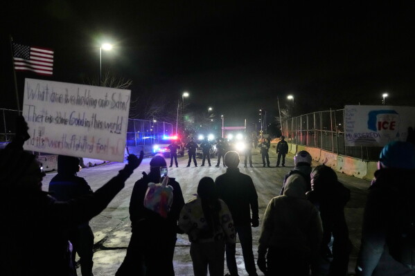Federal immigration officers confront protesters outside Bishop Henry Whipple Federal Building in Minneapolis, on Thursday, Jan. 15, 2026. (AP Photo/Yuki Iwamura, File)
