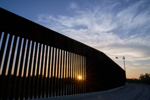 The sun sets over a section of the border wall, June 18, 2025, in Mission, Texas. (AP Photo/Jacquelyn Martin, File)