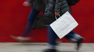 FILE - A person carries a shopping bag in Philadelphia, Dec. 10, 2025.