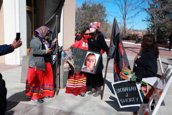 Seraphine Warren, center left, is embraced by state Sen. Shannon Pinto outside the state capitol building on Feb. 4, 2022, in Santa Fe, N.M. (AP Photo/Cedar Attanasio, File)