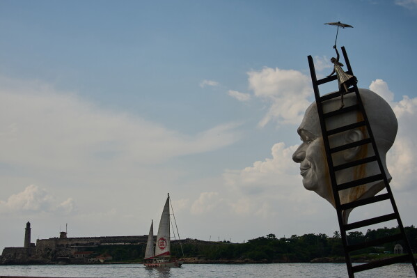 Artwork by Cuban Osmany Betancourt stands on exhibit in Havana Bay where the Astral ship from the Spanish humanitarian organization Open Arms arrives, in Cuba, Sunday, July 19, 2026. (AP Photo/Ramon Espinosa)