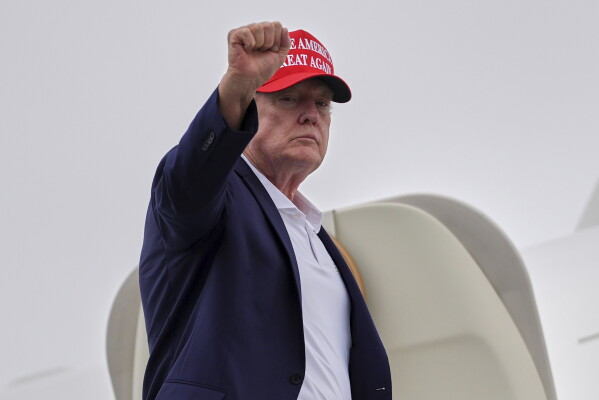 President Donald Trump gestures as he boards Air Force One at Morristown Airport, Sunday, Aug. 16, 2026, in Morristown, N.J. (AP Photo/Julia Demaree Nikhinson)