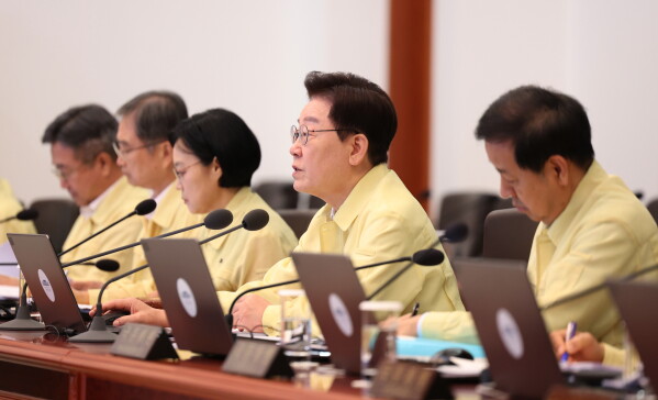 South Korean President Lee Jae Myung, second from right, speaks during a cabinet meeting at the presidential office in Seoul, South Korea, Tuesday, Aug. 18, 2026. (Yonhap via AP)