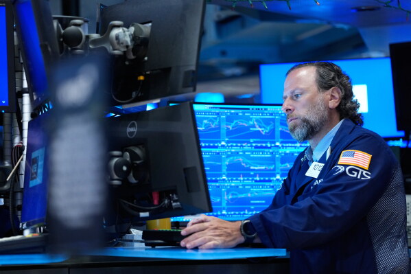 Michael Pistillo works on the floor at the New York Stock Exchange in New York, Monday, July 6, 2026. (AP Photo/Seth Wenig)