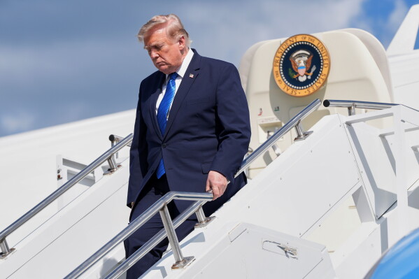 President Donald Trump exits Air Force One at Morristown Municipal Airport in Morristown, N.J., Friday, July 31, 2026, after a trip to Camp David, the presidential retreat. (AP Photo/Jacquelyn Martin)