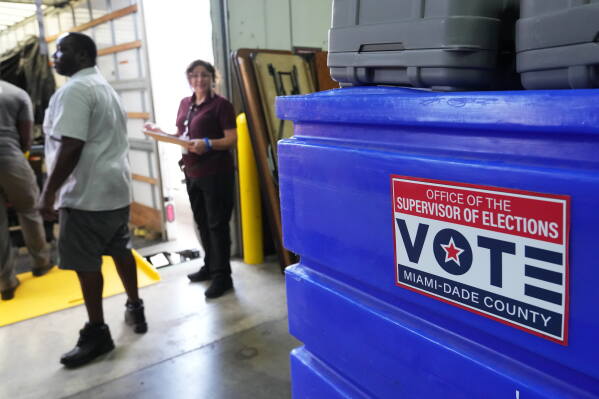 Employees prepare voting equipment at the Miami-Dade Supervisor of Elections Training and Support Center warehouse to be transported to voting precincts in advance of the August 18 Florida primary election, Thursday, Aug. 13, 2026, in Doral, Fla. (AP Photo/Lynne Sladky)