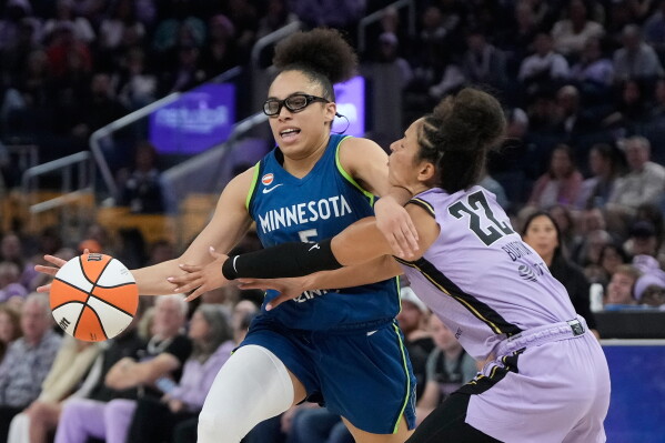 Minnesota Lynx guard Olivia Miles, left, drives to the basket against Golden State Valkyries guard Veronica Burton (22) during the first half of a WNBA basketball game in San Francisco, Wednesday, Aug. 19, 2026. (AP Photo/Jeff Chiu)